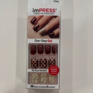 imPRESS maroon and gold press-on nails
